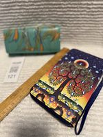 Both wallets with ruler for scale