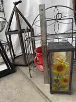 Group view showing stained-glass lantern, two-tier shelf, red teacup planter, hexagonal lantern