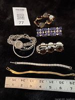 All seven pieces laid out with ruler for scale