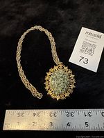 Full necklace with ruler showing pendant width and chain section