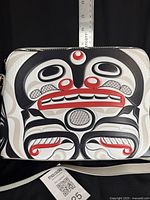 Front view of the bag showing killer whale art and detachable strap