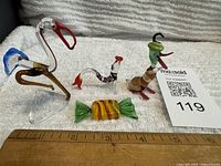 Overall lot with four glass pieces and ruler for scale