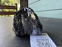 Front view of galena specimen beside ruler and QR card