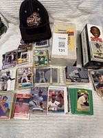 Overall shot showing bundles of sports cards, Donruss box, cap and bobblehead box