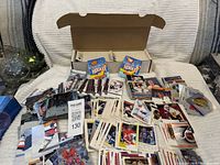 open shoebox of assorted hockey cards with two sealed Tim Hortons packs and several loose stacks