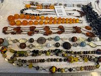 Overview of all necklaces laid out on white towel