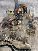 Overview of mixed bead and finding lot including pearl strands, glass beads, packaged metal beads and craft wire