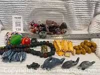 overview of dolphins, bead strands, assorted stones in tub