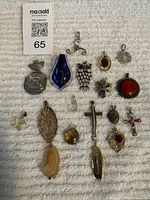 All 16 assorted pendants laid out on towel