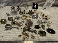 Group shot of entire lot of pins and brooches