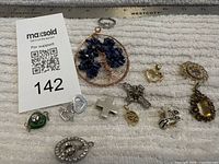 Overview of bracelet and multiple pendants on ruler background