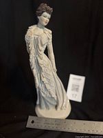 Front view of figurine with ruler showing scale