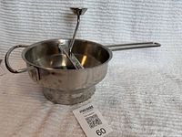 food mill assembled, side profile with crank and handles visible