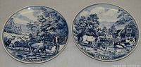 Front view of both Delft plates showing Spring and Autumn designs