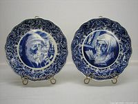Both Boch Freres Delft plates on stands, showing design and scale