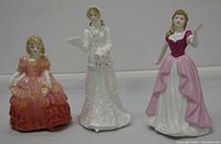 Front view of three Royal Doulton figurines