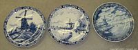 Group view of three Delft Blue windmill plates