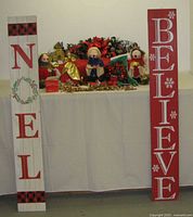 Overall lot with two porch signs, swag and table of decorations