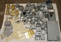 Entire lot laid out showing subpanel, boxes, plate covers, thermostats, receptacles, screw jar