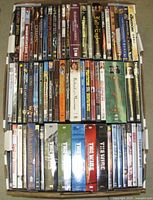 Top view of two layers of DVD cases showing variety of titles and seasons