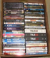 Box containing four columns of stacked DVD cases