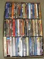 Box containing two layers of DVD cases showing spines