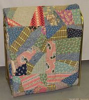 Quilt folded over rack showing patchwork and rack structure