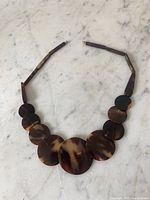 Full view of graduated shell disk necklace