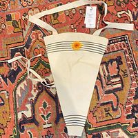 Full view of cone-shaped sunflower canvas tote with strap and tag