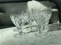 Front view of five cut crystal goblets