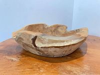 Side view of carved hardwood bowl showing resin inlay