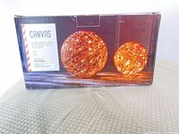 Retail box showing two illuminated rattan globes and brand information