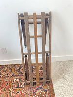 Stand folded for storage showing slatted construction