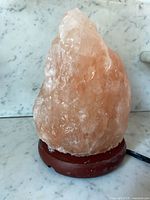 Salt lamp unlit on marble surface