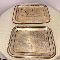 Two rectangular pewter trays showing full view