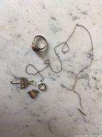 All four jewellery items laid out