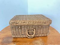 Closed rectangular wicker basket showing lid and handle