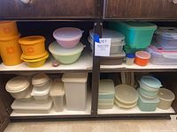 Shelved assortment of Tupperware containers in various shapes, sizes and colors