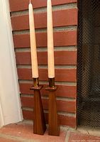 Full view pair of candlesticks with candles inserted