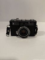 Front view of GAF Memo 35EE camera showing lens, branding and strap