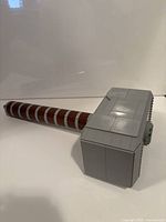 Full view of assembled LEGO Thor's Hammer lying on side