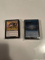 Two sealed plastic-wrapped stacks of Magic cards