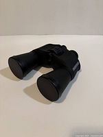 Binoculars front view with objective lens caps on