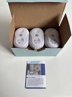 Three pest repellers in open box with manual