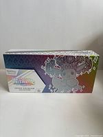 Front of closed Super Premium Collection box with rainbow gradient and Diancie art