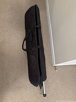 Black zippered carry bag with stand visible