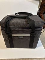 Exterior of grey Tenba soft case with handles and strap