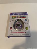 Front of packaged Bandai Original Tamagotchi showing toy in blister pack