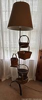 Full view of lamp with shade and attached baskets