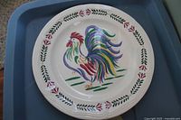 Close view of rooster motif dinner plate
